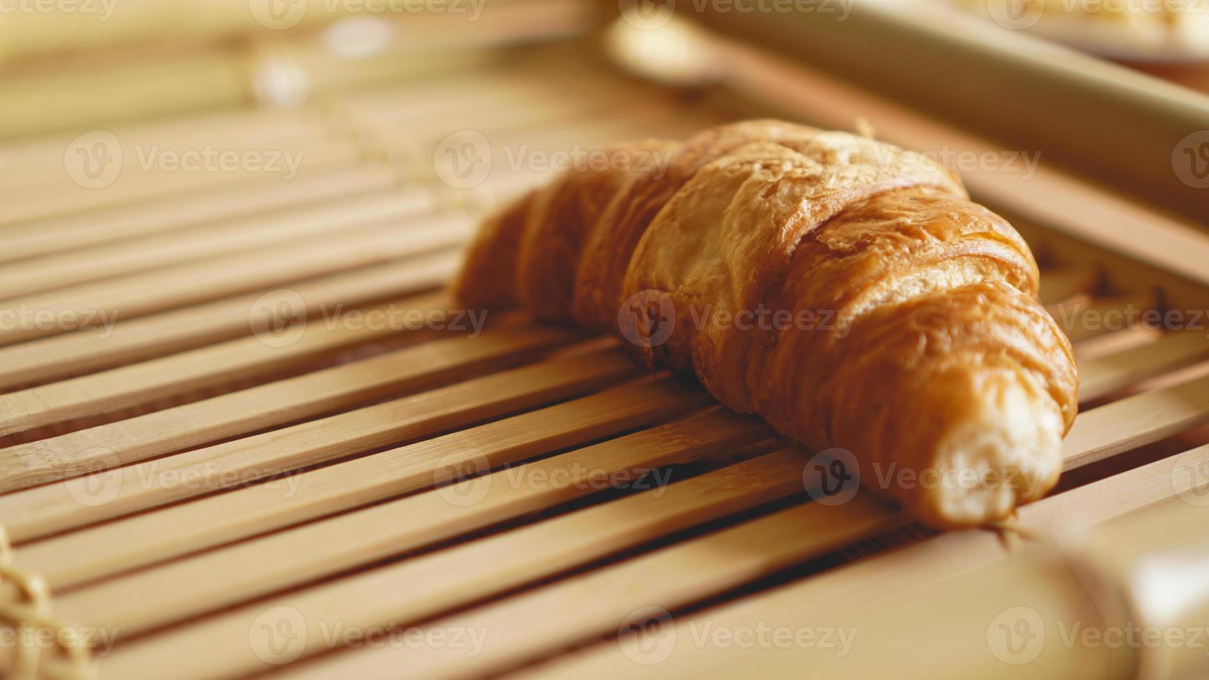 Fresh Croissants on rustic wooden background photo