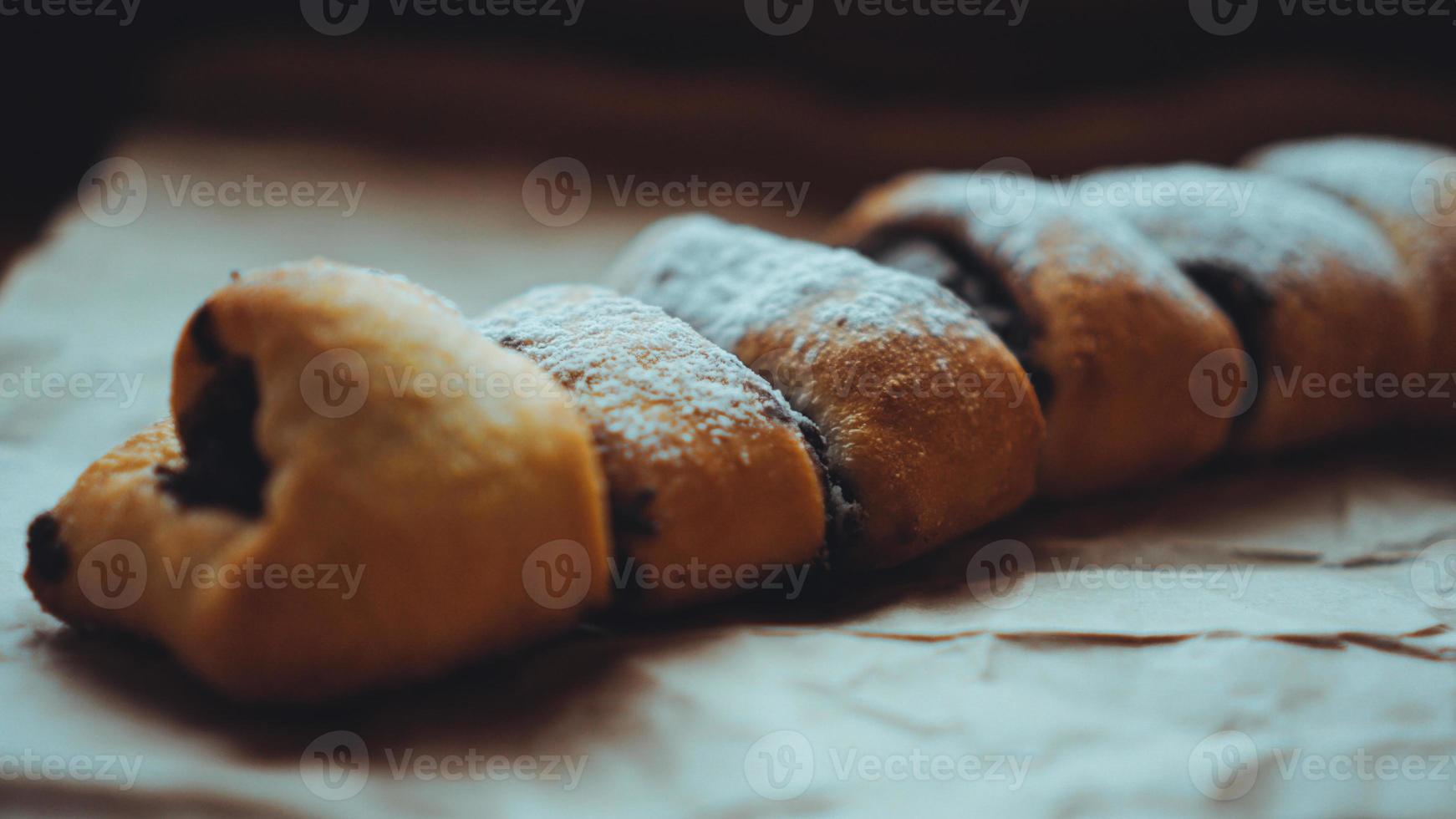 Chocolate Rolls sprinkled with powdered sugar photo