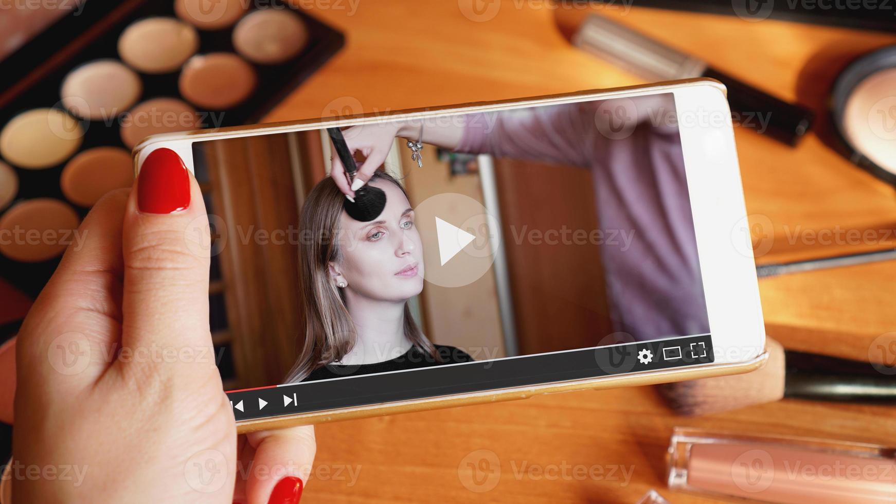 Woman watching online training for professional makeup artist photo