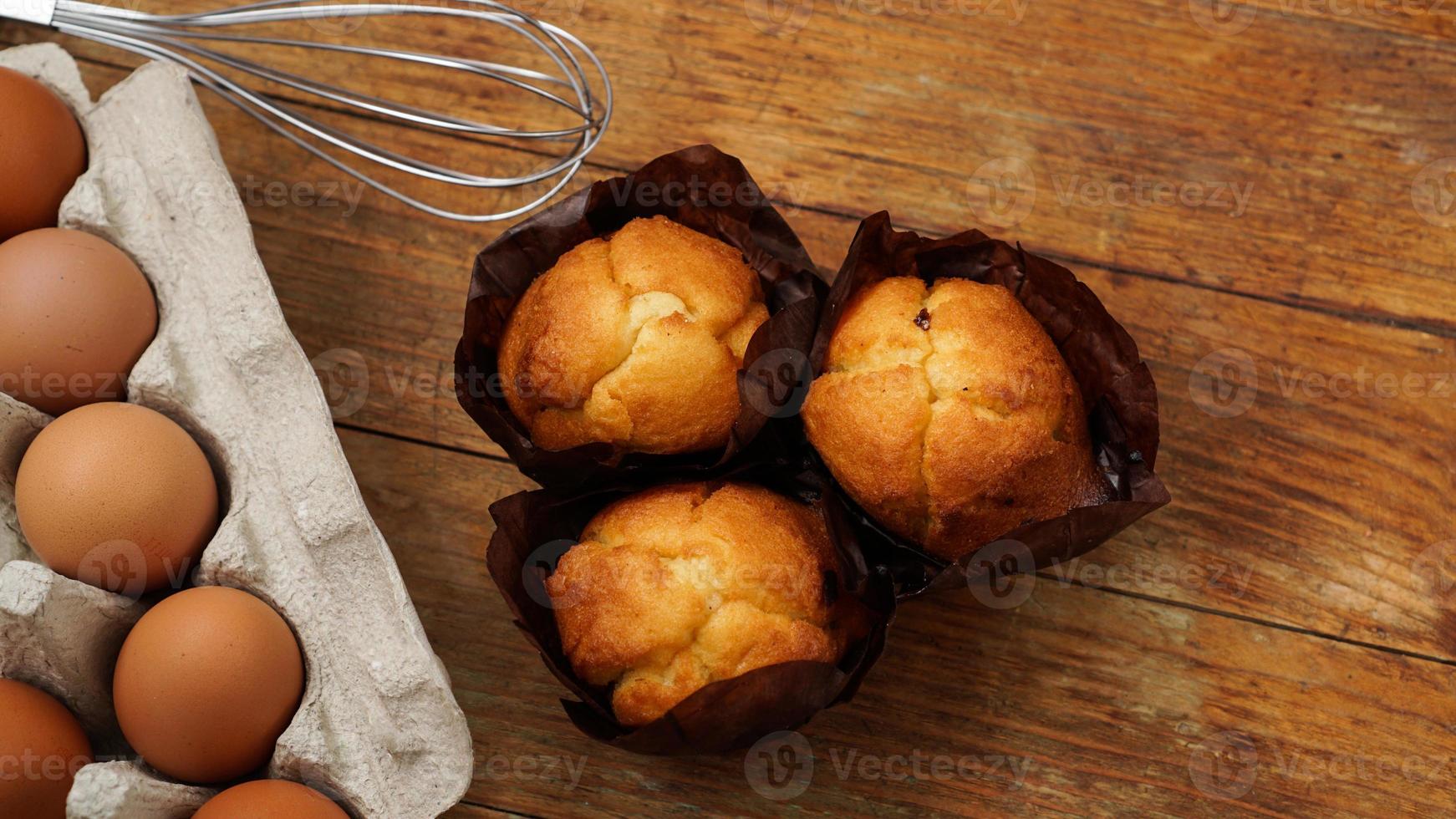 Magdalenas y muffins horneados sobre un fondo de madera rústica foto