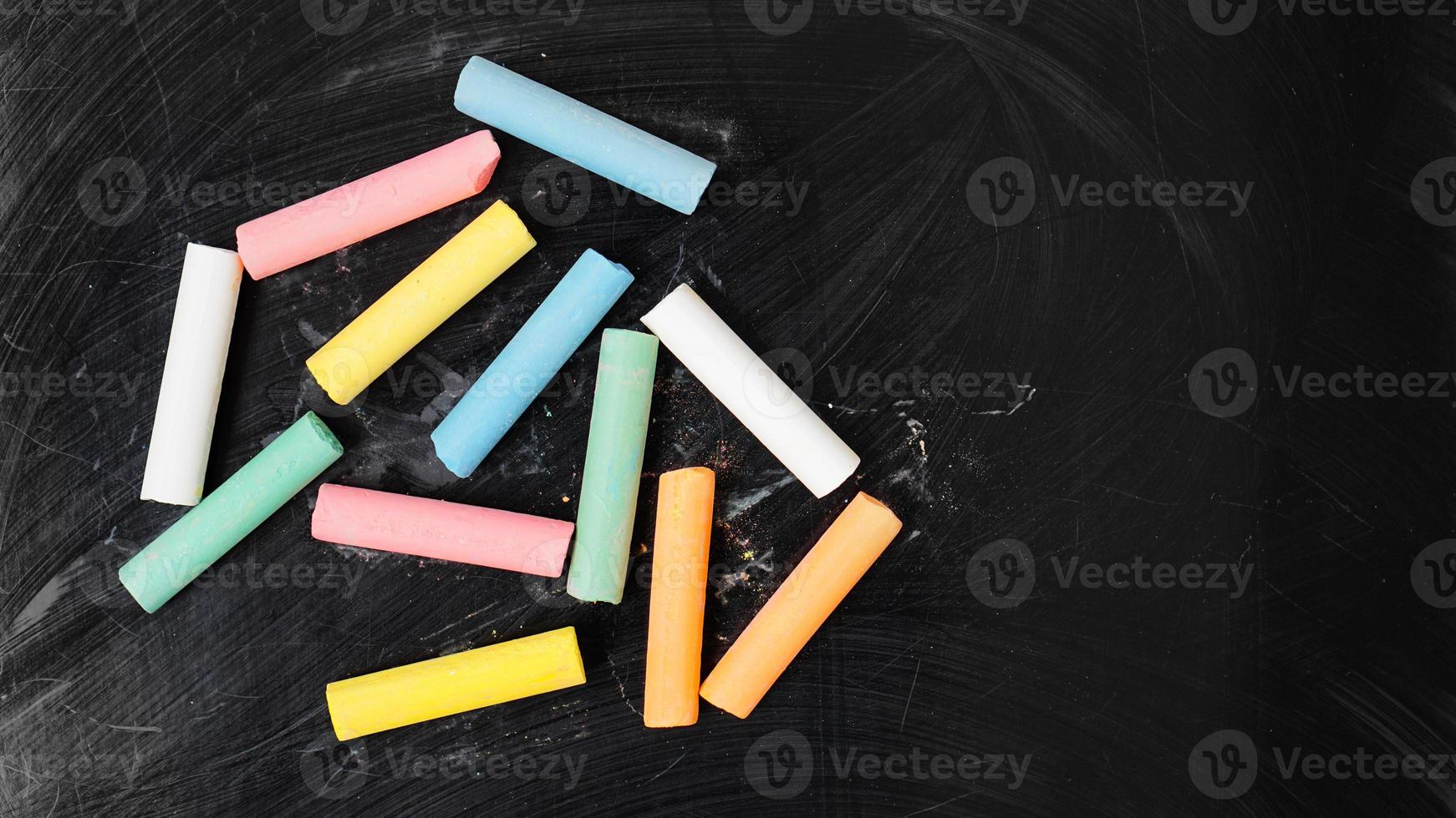 Colored chalk on a blackboard. Blackboard with crayons photo