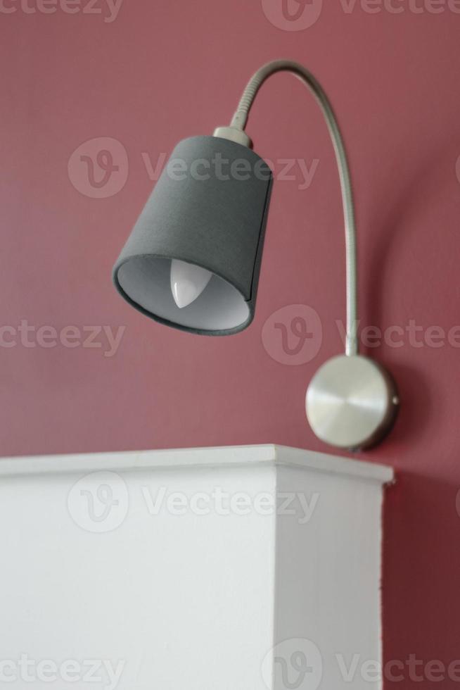 Modern design bed lamps detail in contemporary bedroom interior at daytime photo