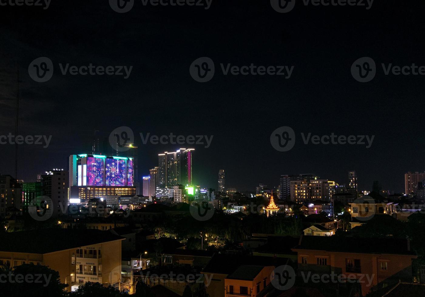 Downtown central Phnom Penh city night view in Cambodia with Naga World casino complex and Koh Pich Diamond Island skyline photo