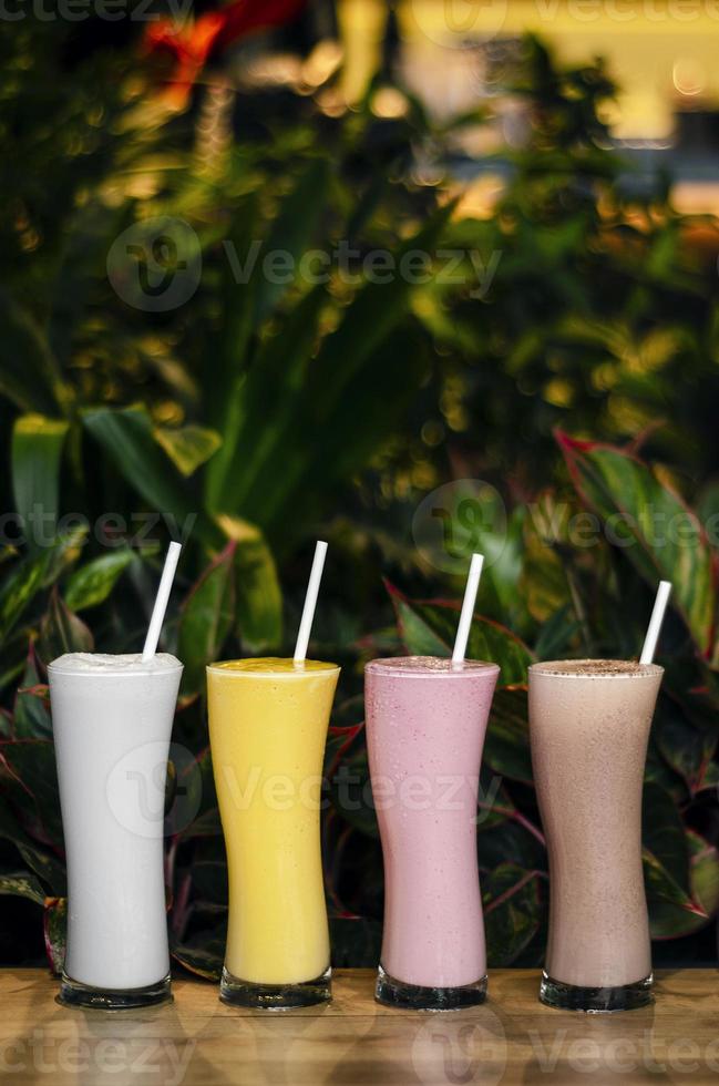 Mixed organic coconut, strawberry, chocolate, and mango ice cream milk shakes photo