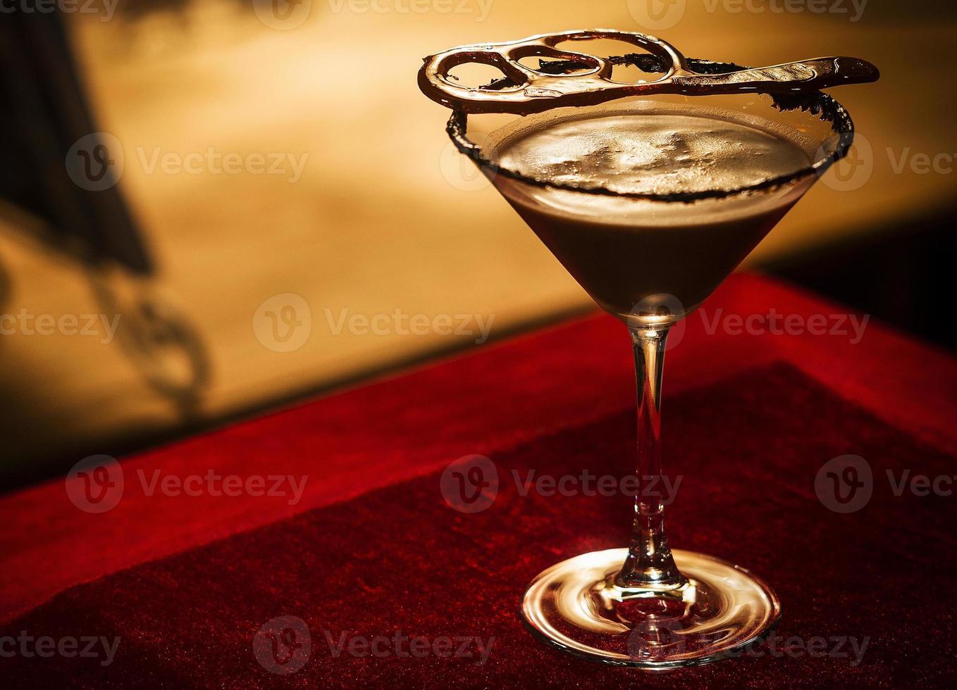 Chocolate caramel cream martini mixed cocktail glass inside cozy bar photo
