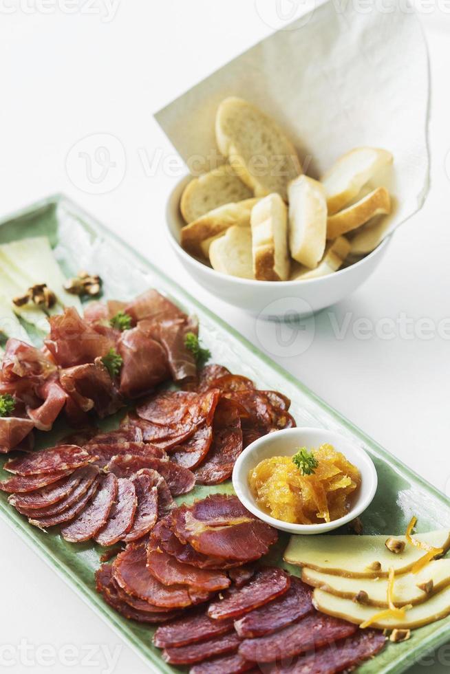 Spanish serrano ham chorizo sausage and cheese tapas traditional snack platter photo