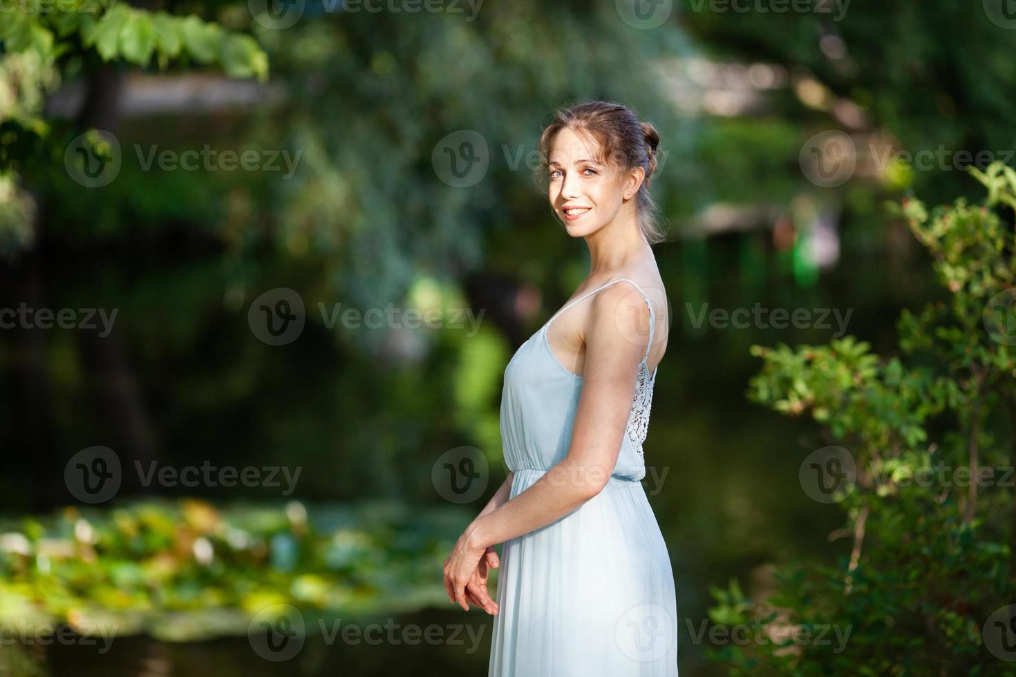 Beautiful young woman in blue dress photo