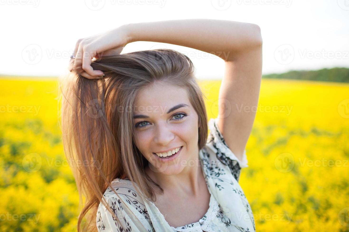 Girl with long hair of yellow wildflowers photo