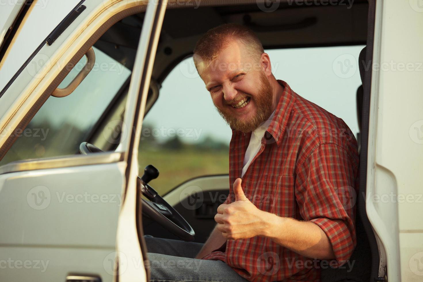 Driver of the car shows that he is doing well photo