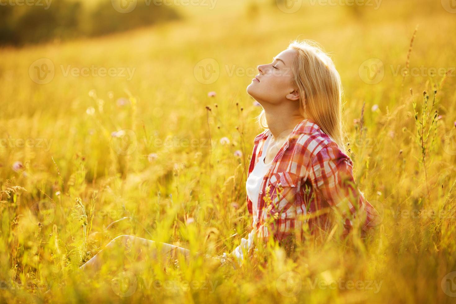 Girl with closed eyes in wildflowers photo