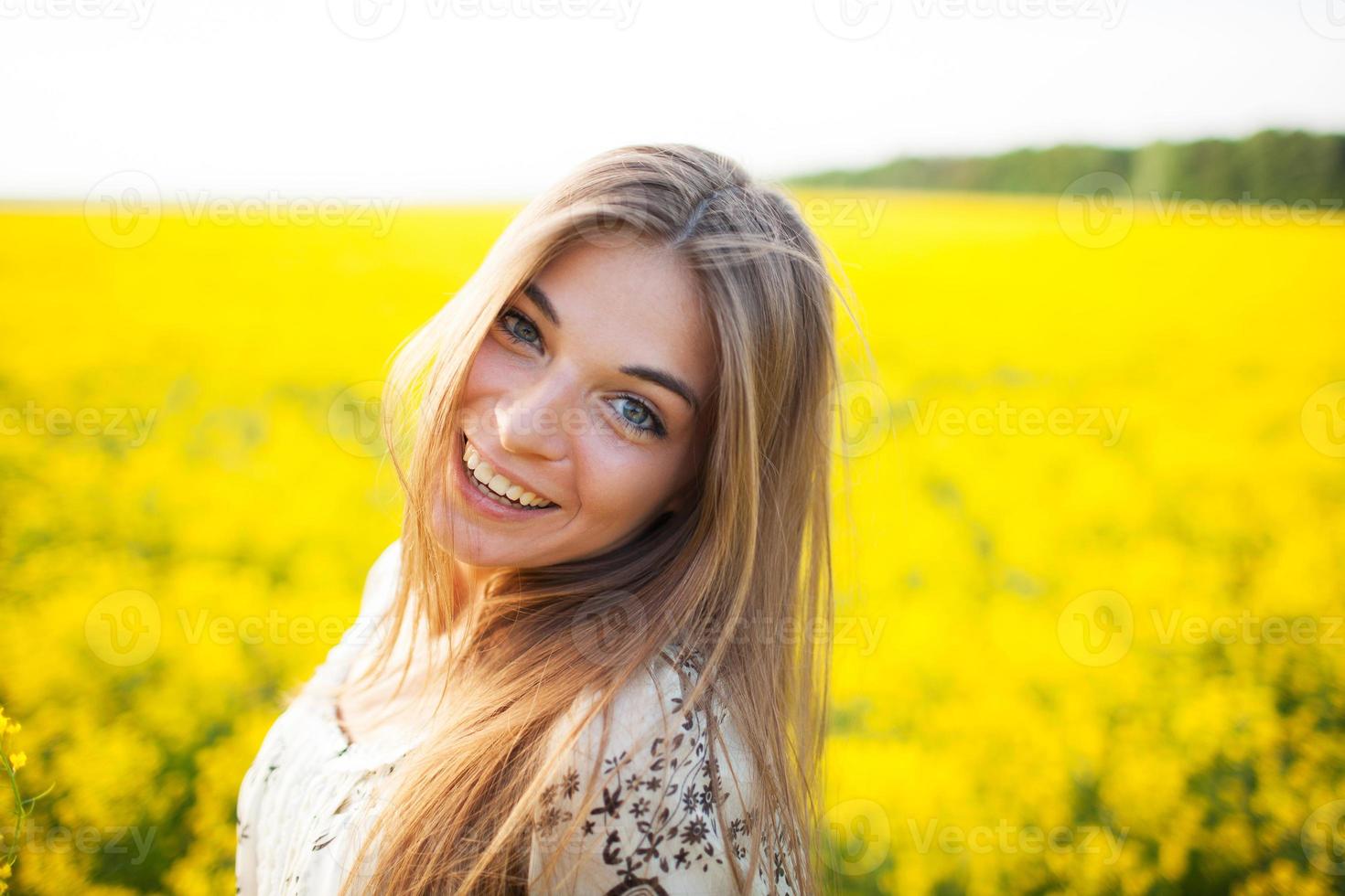 Beautiful young woman of yellow wildflowers photo