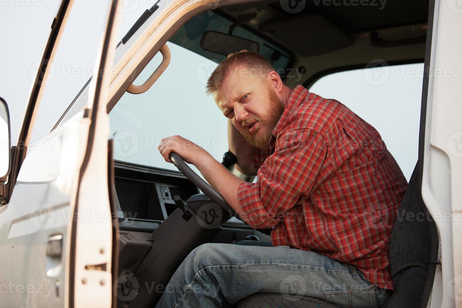 Somewhat puzzled bearded driver in the cab photo