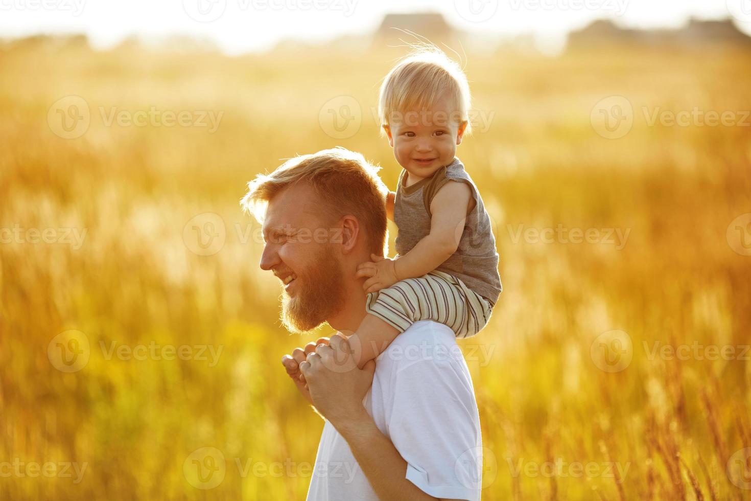 Happy father carries his son photo