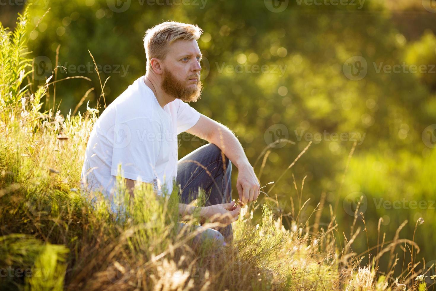 Guy sitting on the grass photo