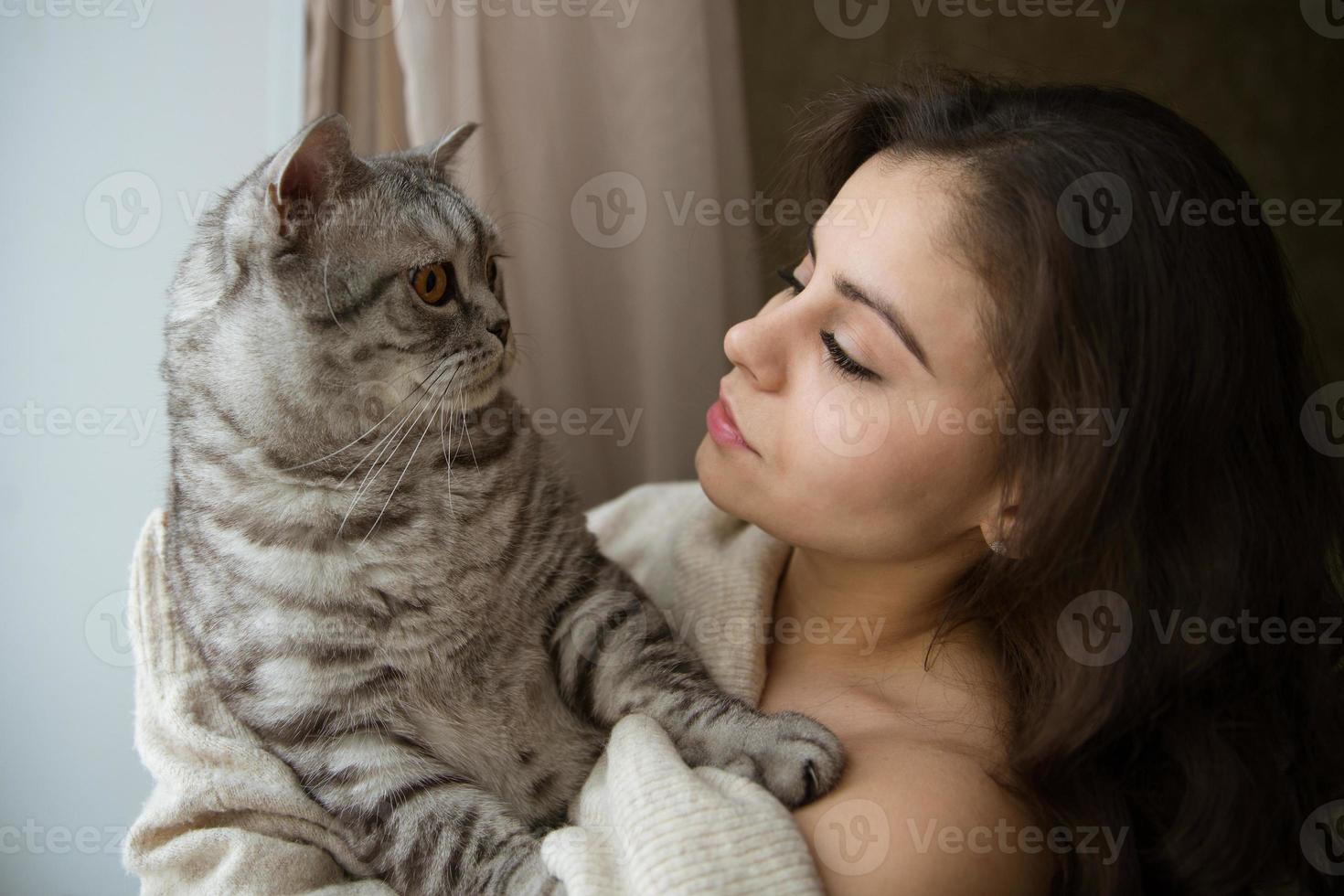 Girl holding a big gray cat photo