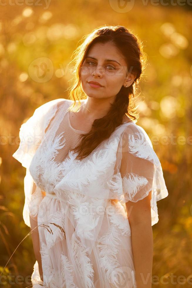 Beautiful girl in a white dress photo