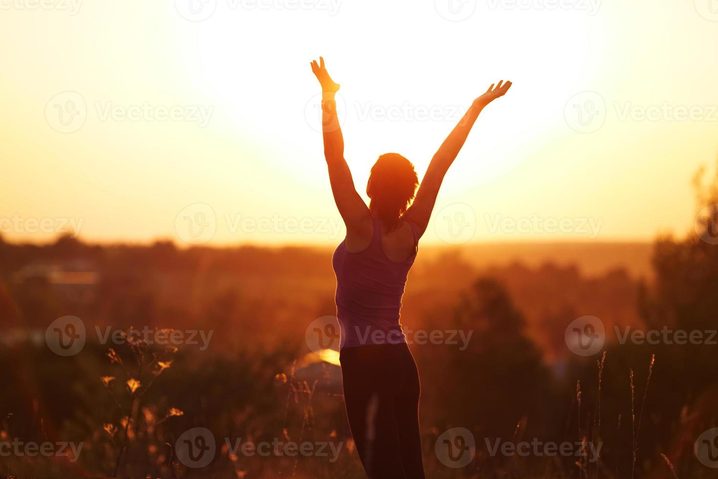 Young woman in evening summer field photo