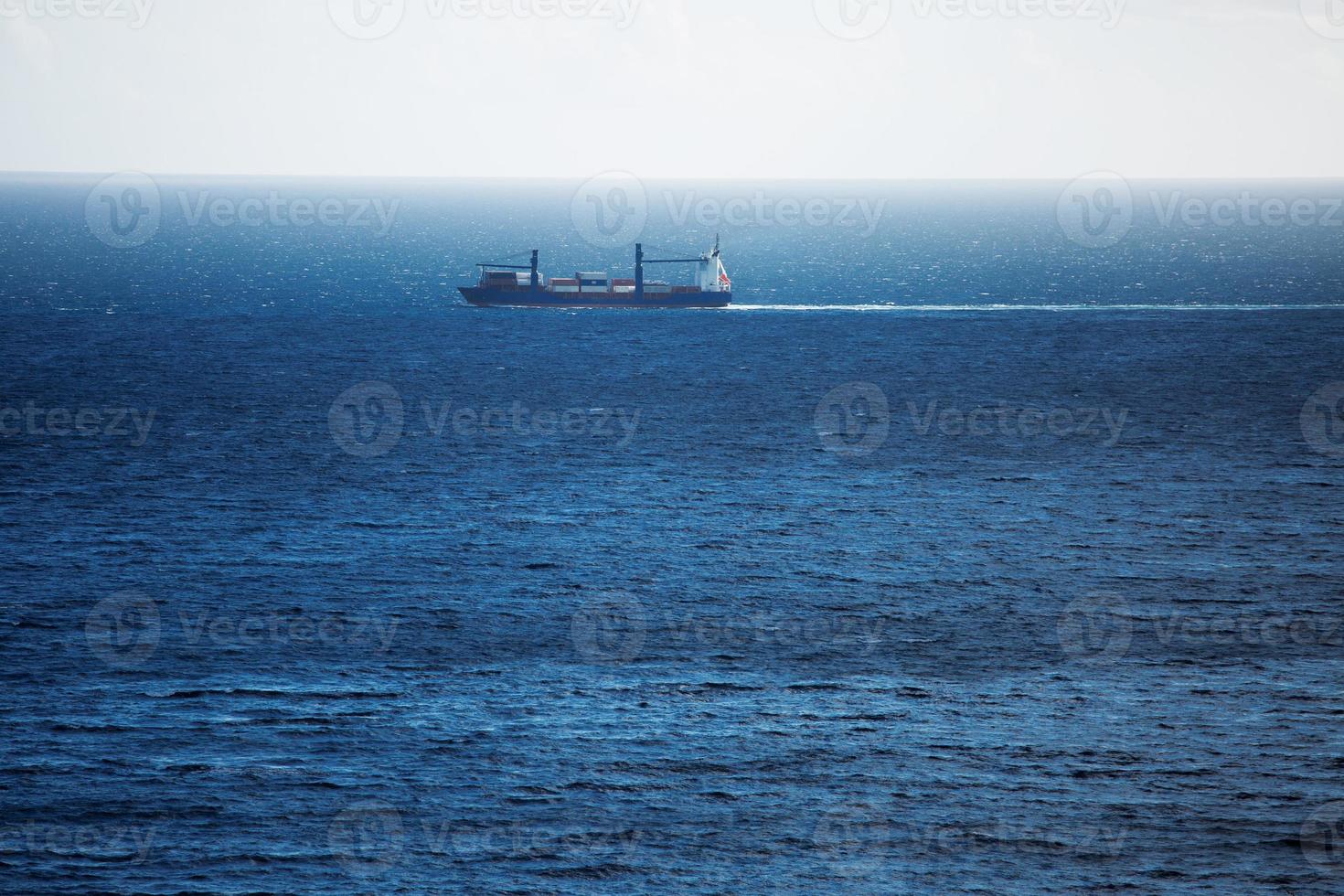 Cargo ship carries swims across the ocean photo