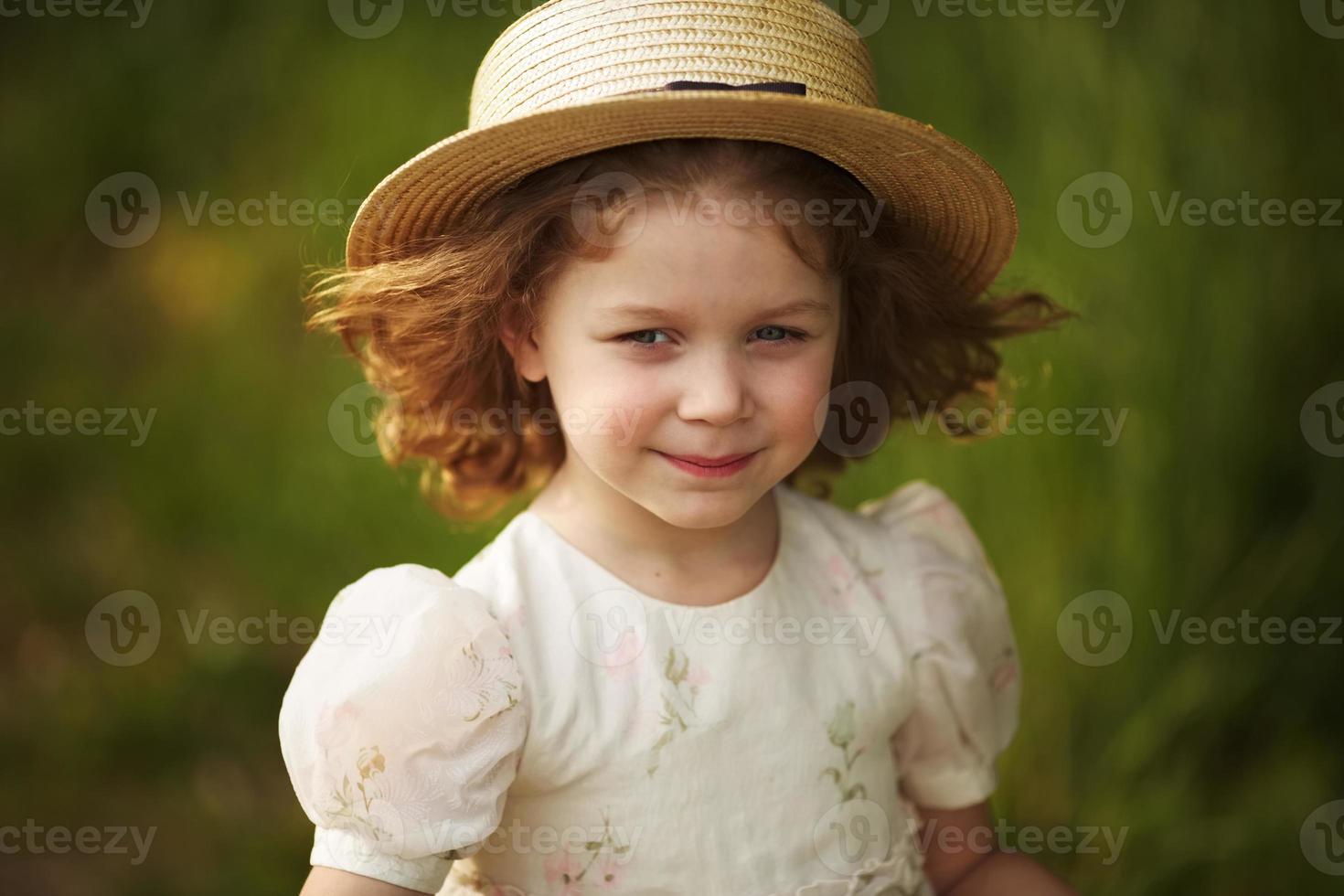Beautiful little girl in a hat photo