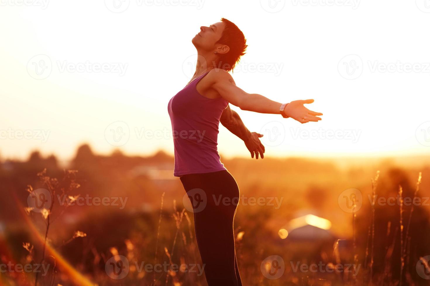 Happy young woman with arms outstretched photo