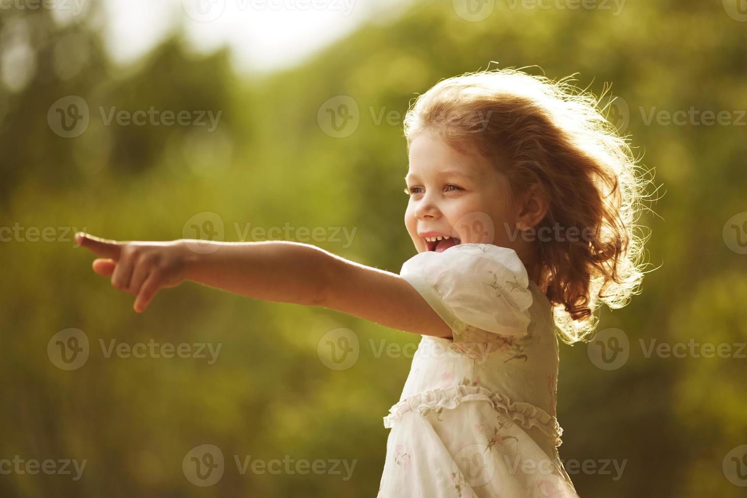 Happy curly girl showing hand forward photo