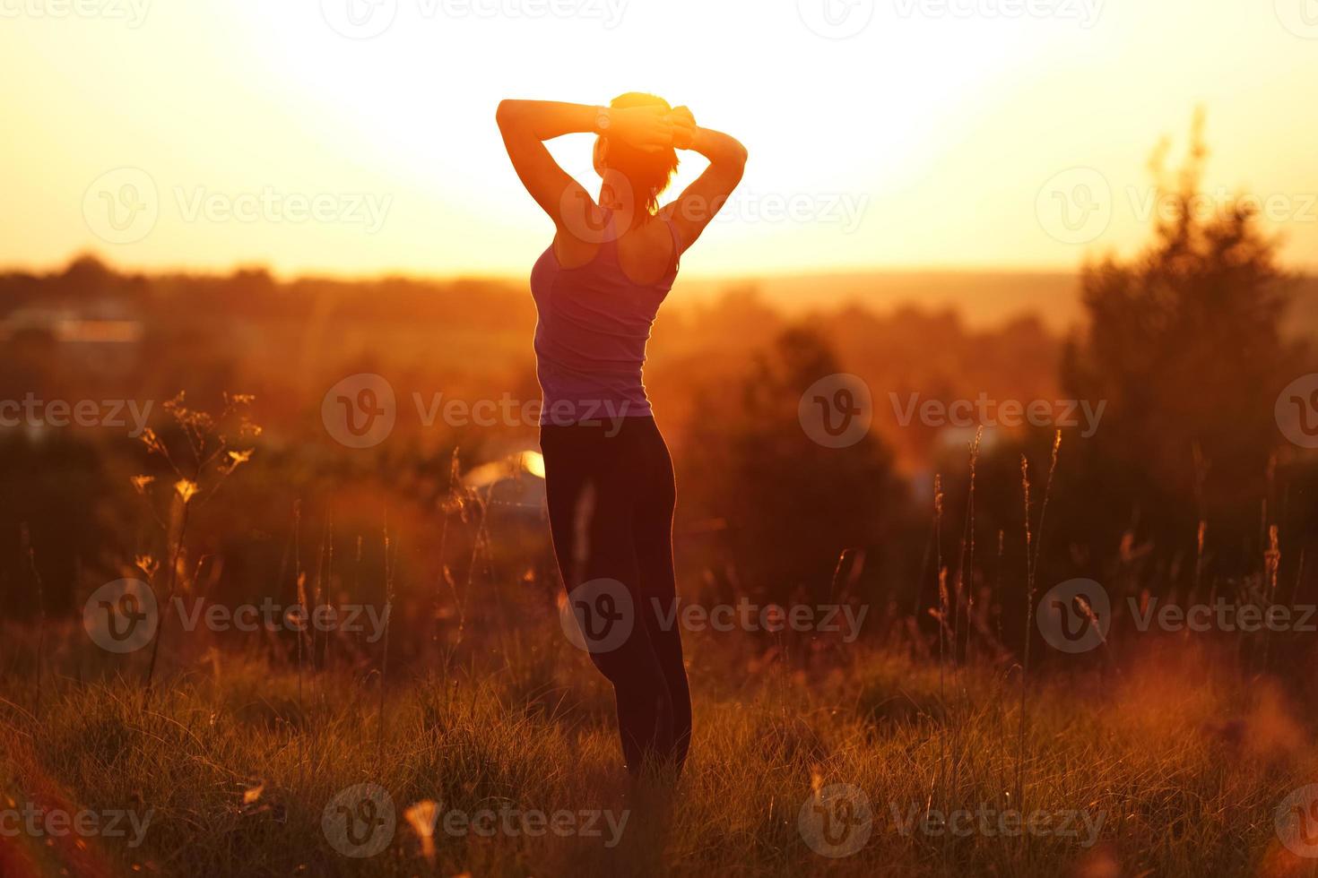 Happy girl standing in a field photo