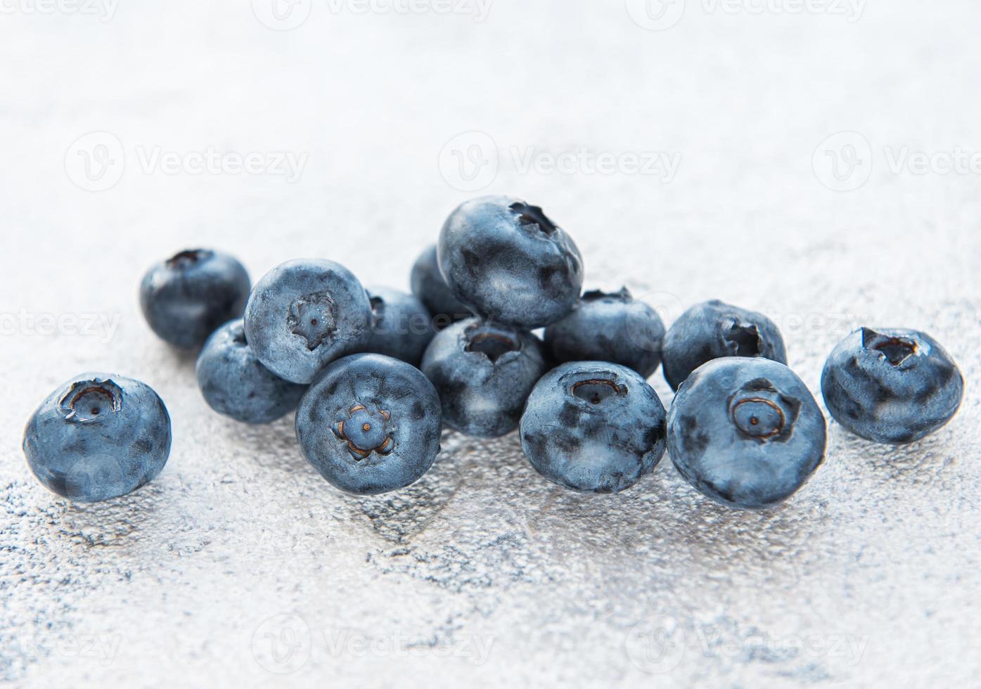 Blueberries on grey concrete background photo