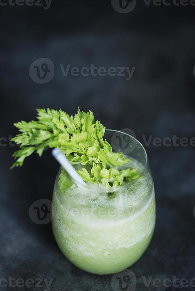 Healthy fresh detox green vegetable smoothie juice with celery and cucumber photo