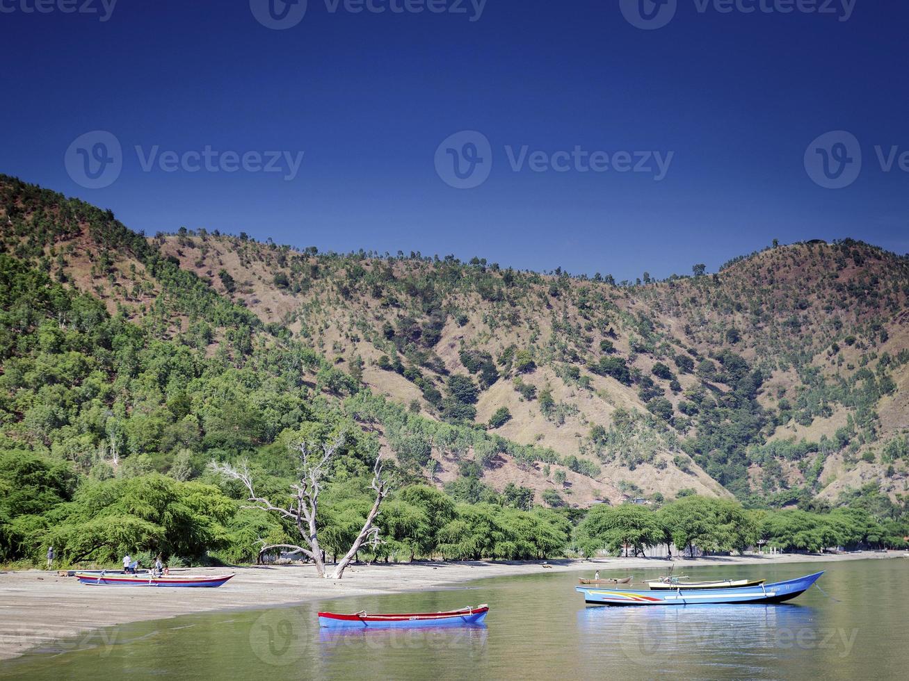 Coast with traditional fishing boats on Dili beach in east Timor Leste photo