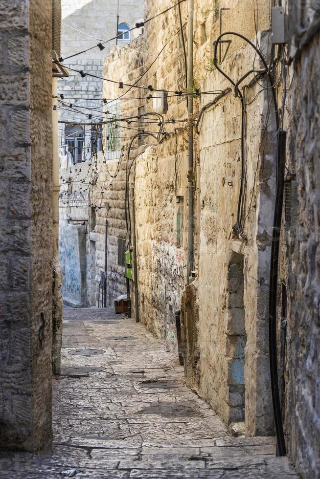 Old town cobbled street scene in ancient Jerusalem city Israel photo