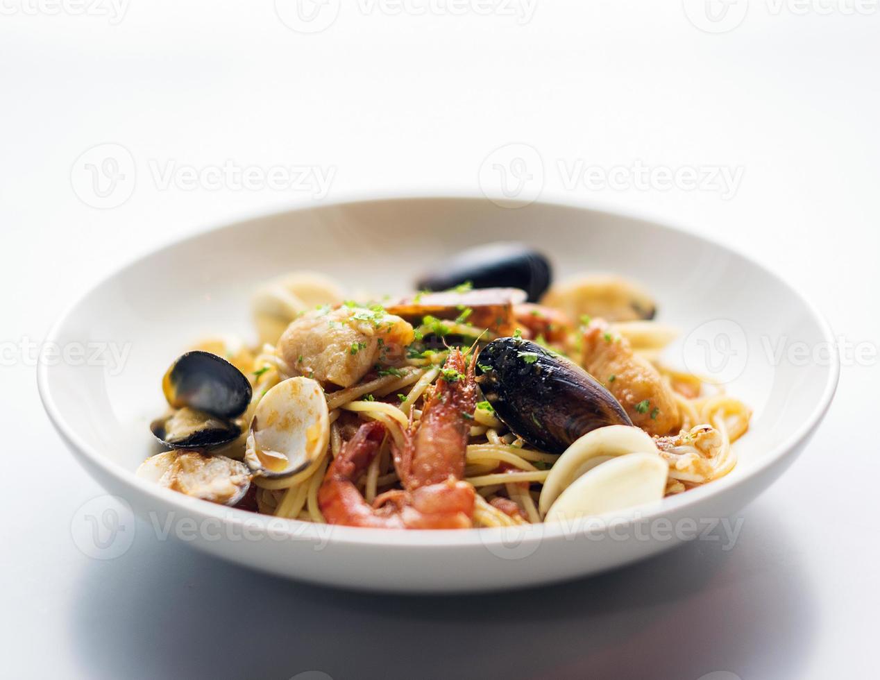 Mussels shrimp and fish seafood and spicy tomato puttanesca marinara pasta photo