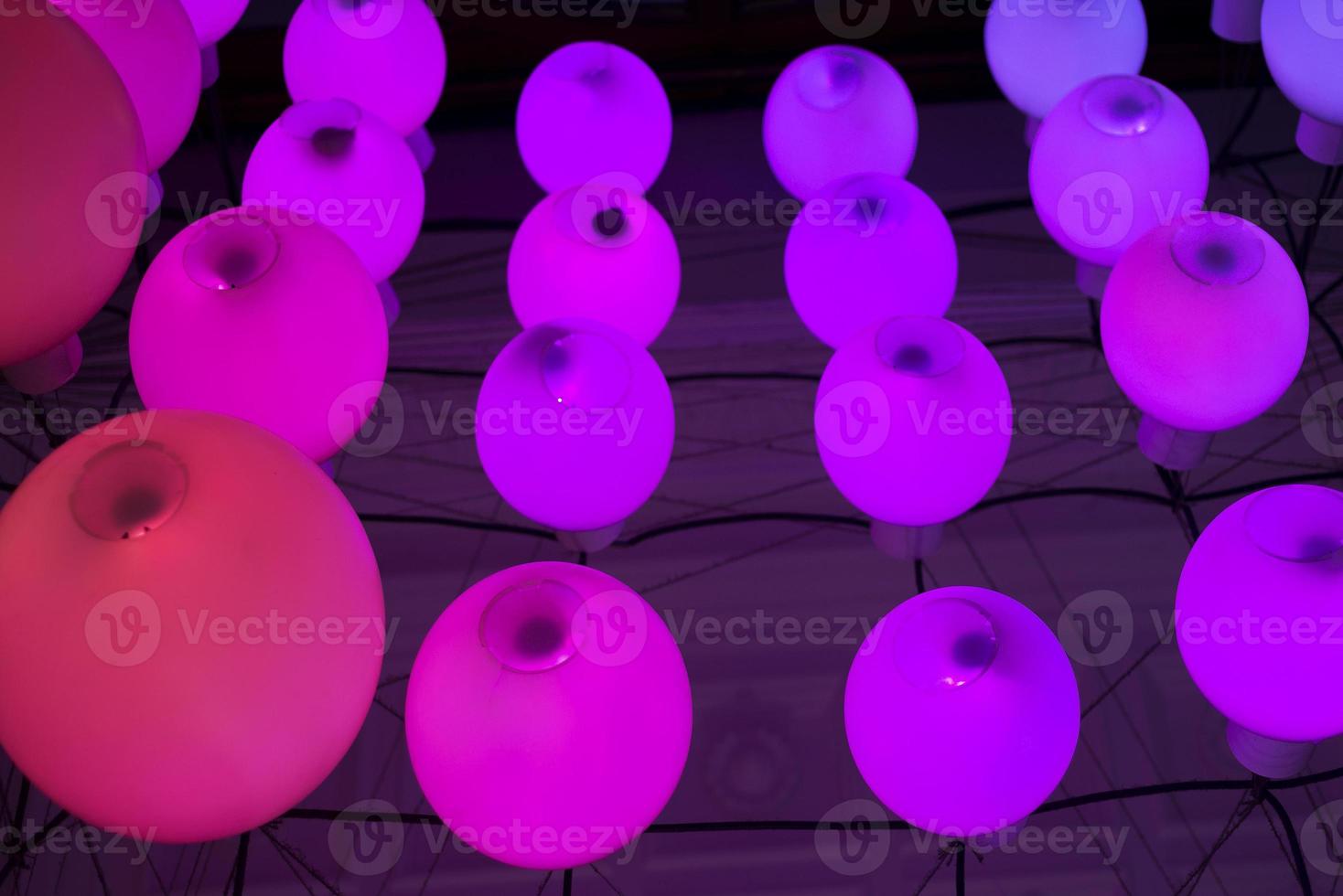 Colorful round pink lights in funky modern interior design detail photo