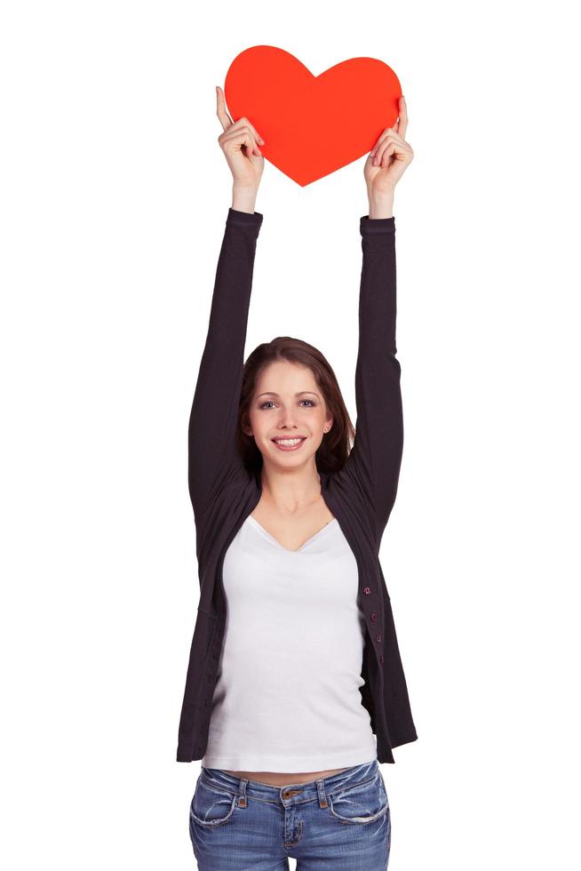 Cheerful dark-haired girl holding a heart over head photo