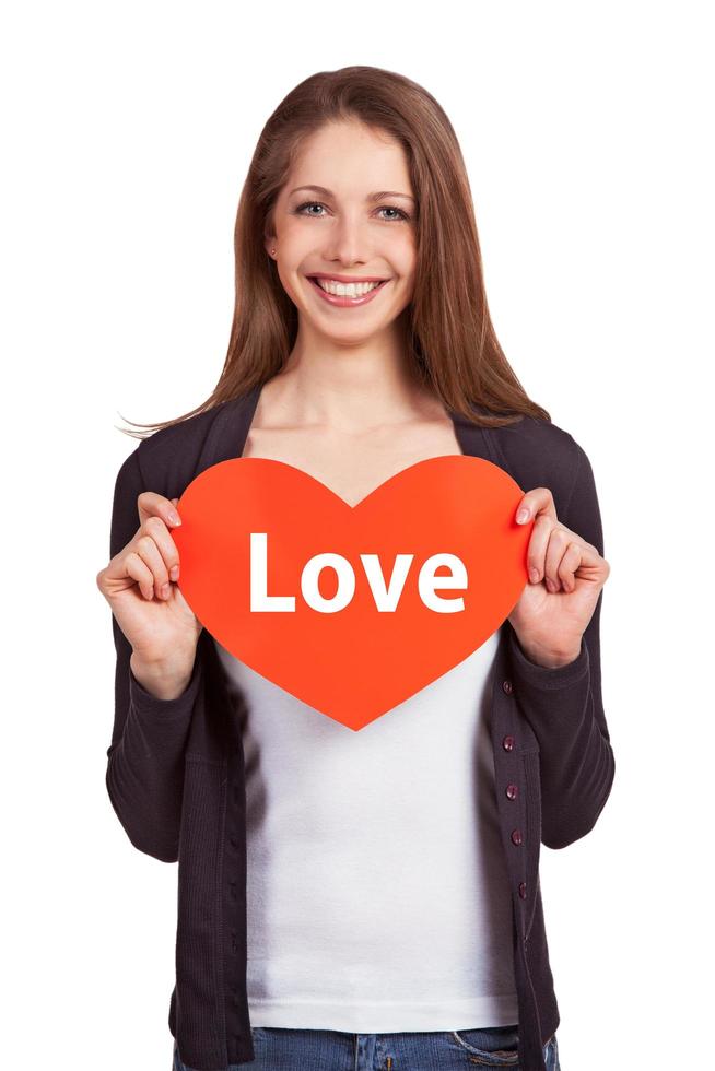 Pretty young girl holding a heart photo