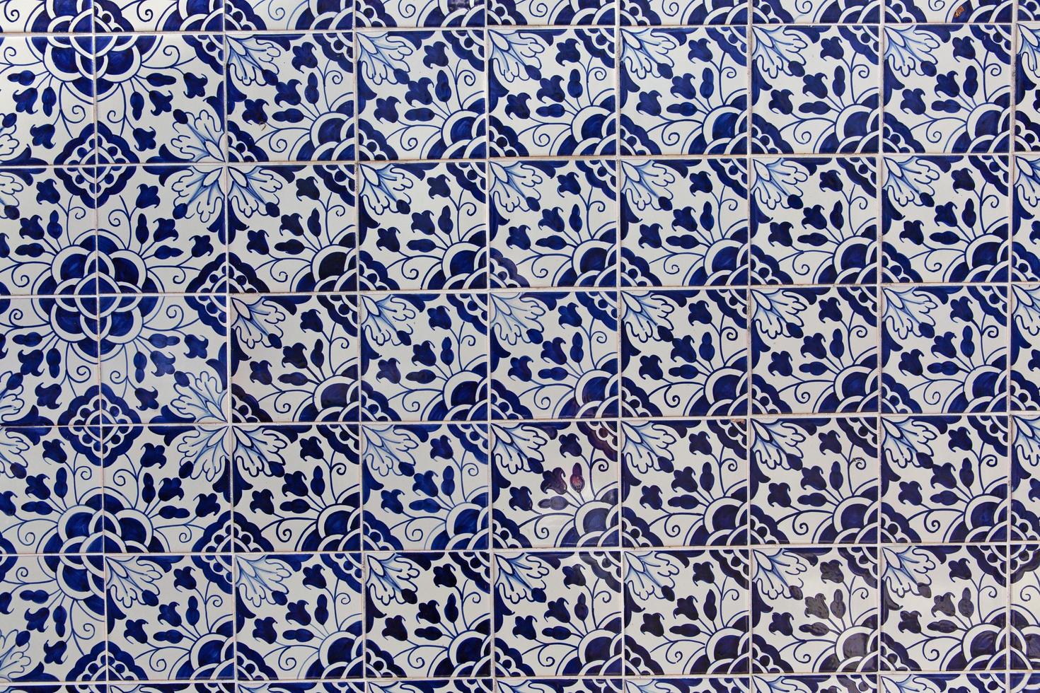 The wall of the house, faced with blue ceramic tiles photo