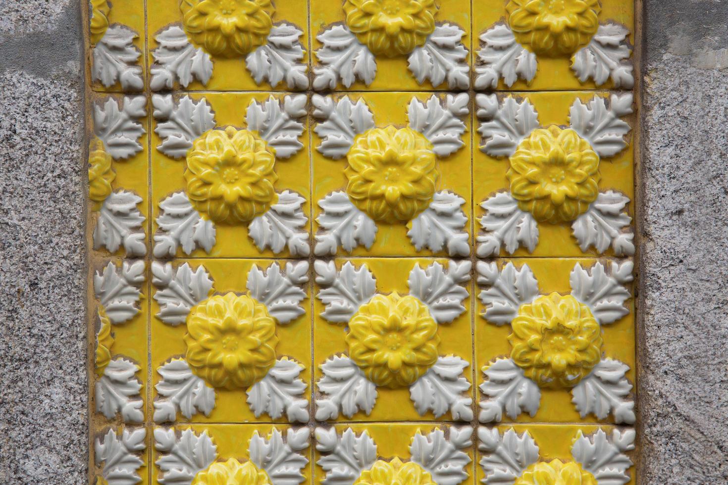 Stone wall decorated with portuguese azulejo tiles photo