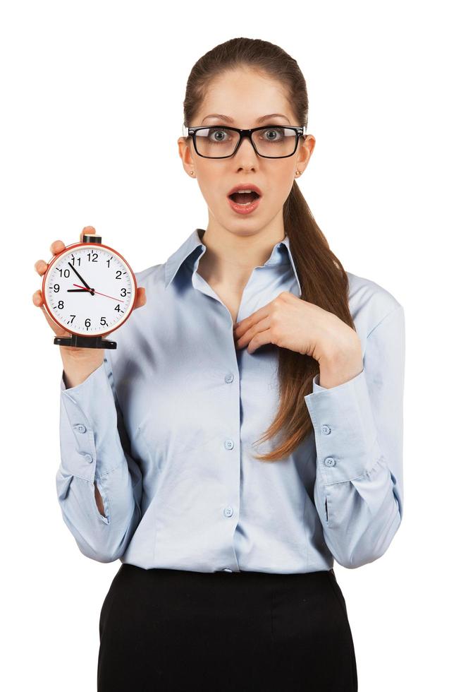 Surprised woman with an alarm clock in hands photo