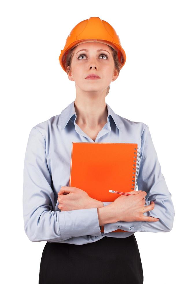 Woman in a protective helmet looking up photo