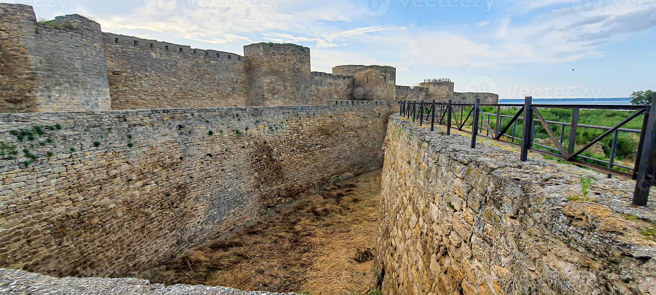 Ruined old fortress on the seashore. Blue sky. photo