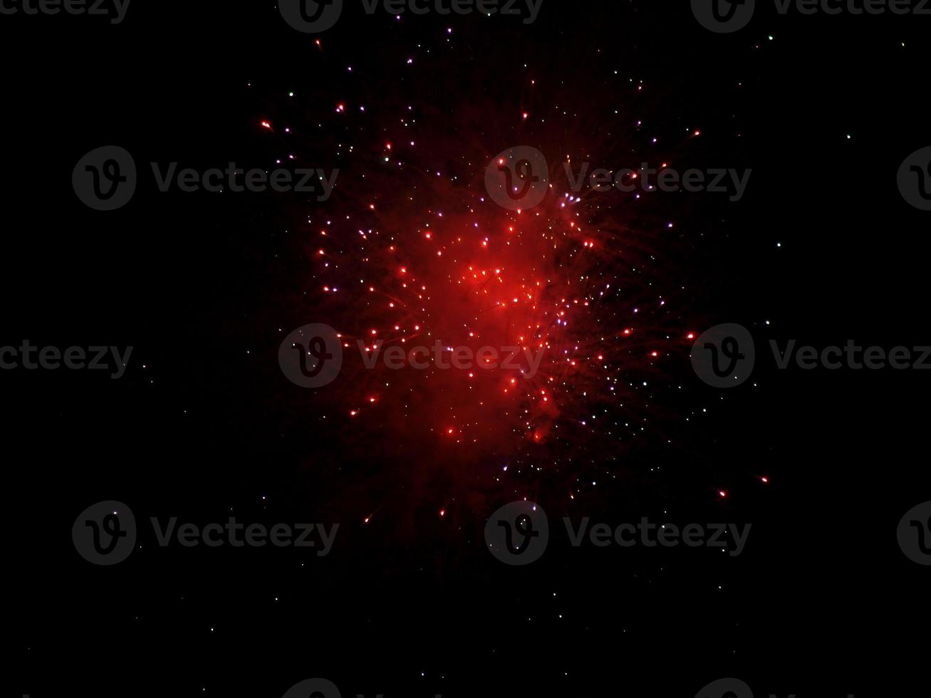 Red fireworks over black sky photo