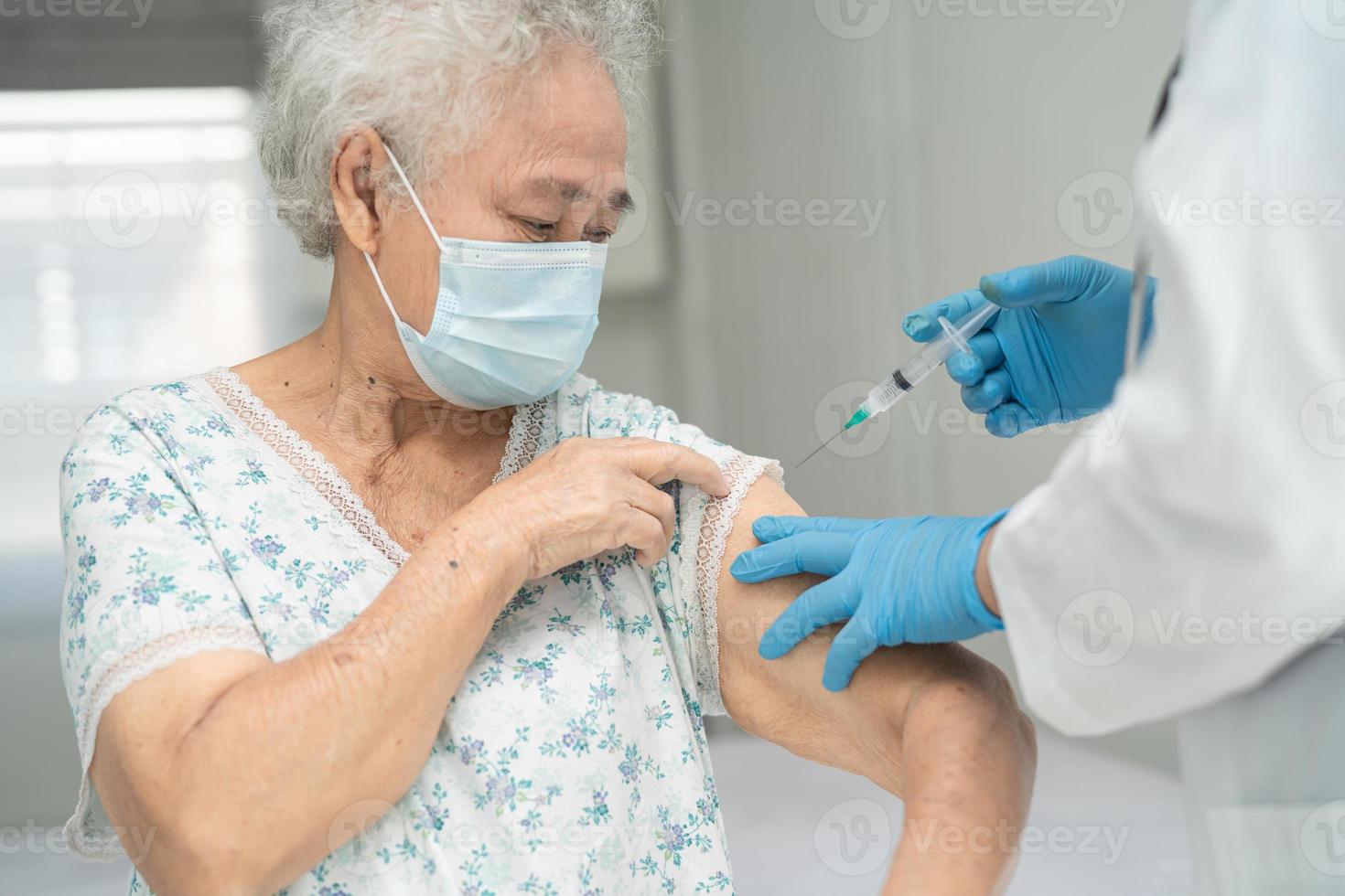 anciana asiática mayor que recibe la vacuna covid-19 o coronavirus foto