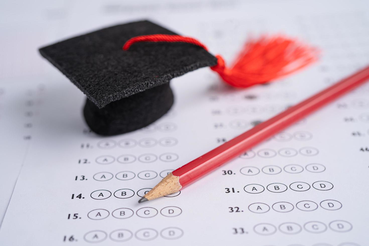 Graduation gap hat and pencil on answer sheet photo