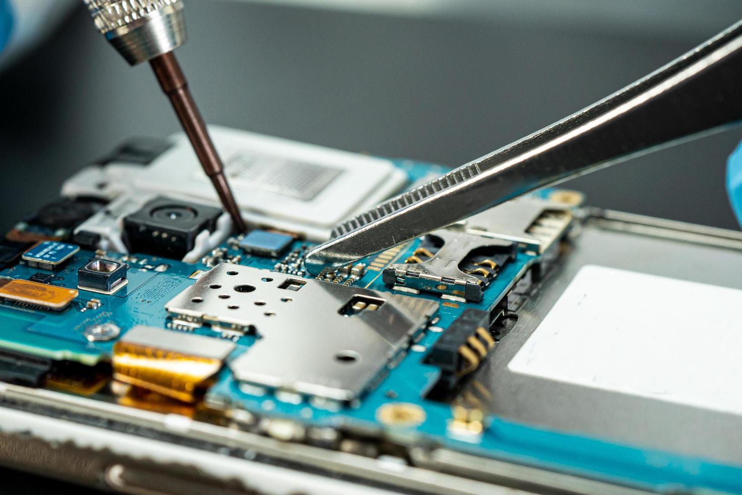 technician repairing inside of hard disk by soldering iron. photo