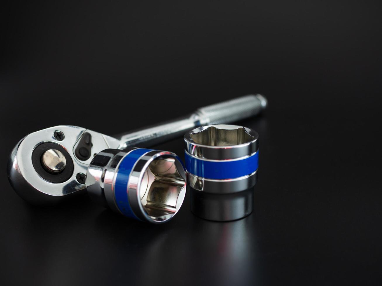 Block wrench set and ratchet wrench on a black background photo