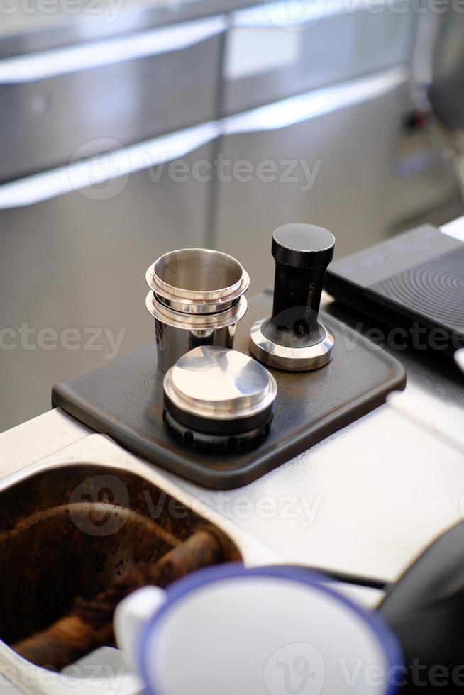 Coffee tamper view from a barista desk. Coffee concep photo