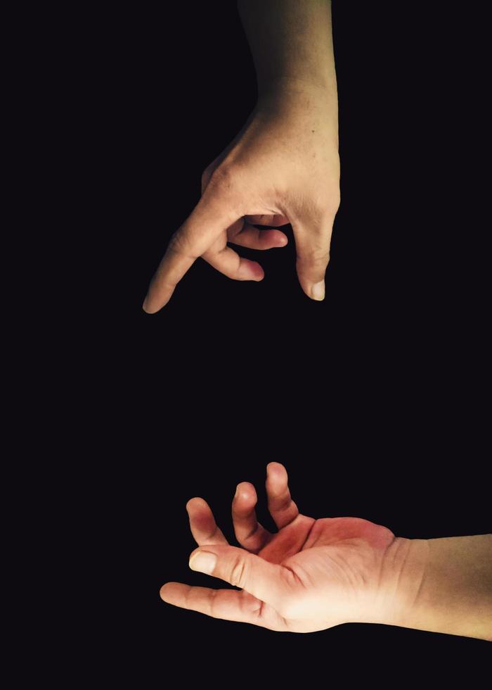 Two hands interaction gesture image on black background photo