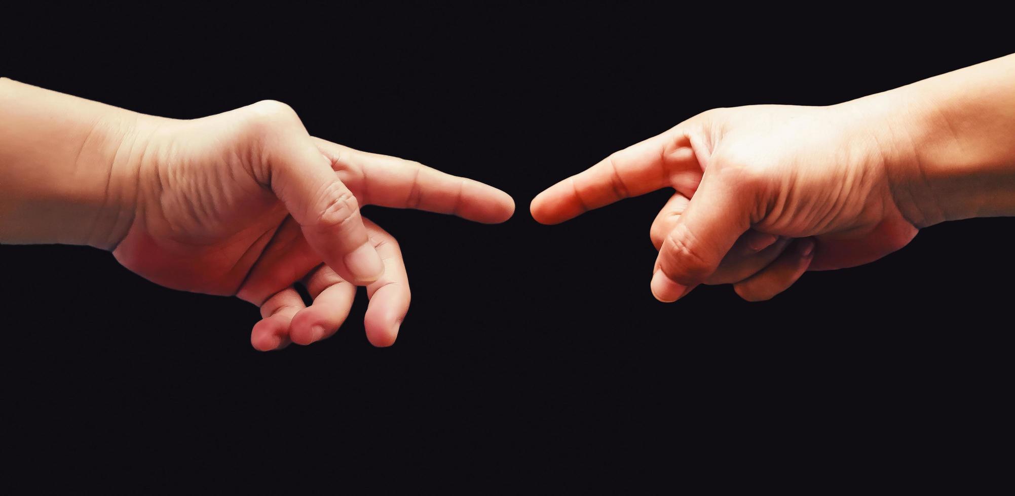 Two hands interaction gesture image on black background photo