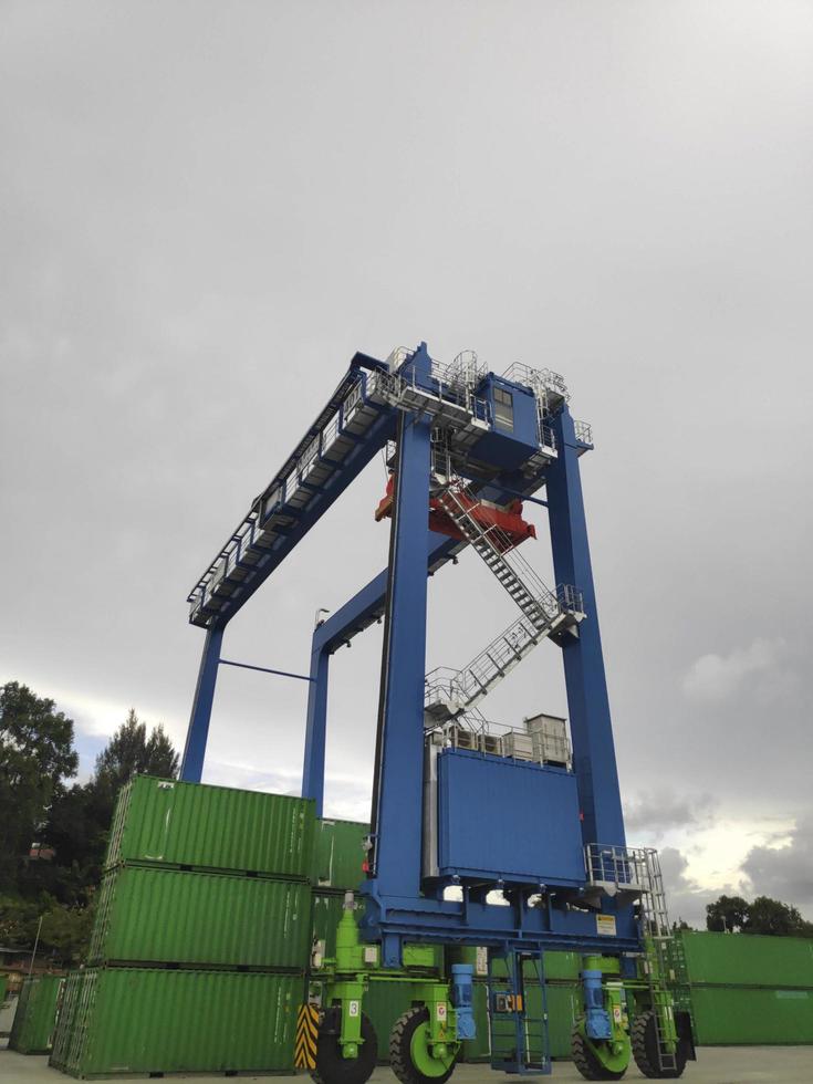 Sorong, West Papua, Indonesia 2021- A Rubber Tyred Gantry Crane on the yard of Sorong Harbour photo