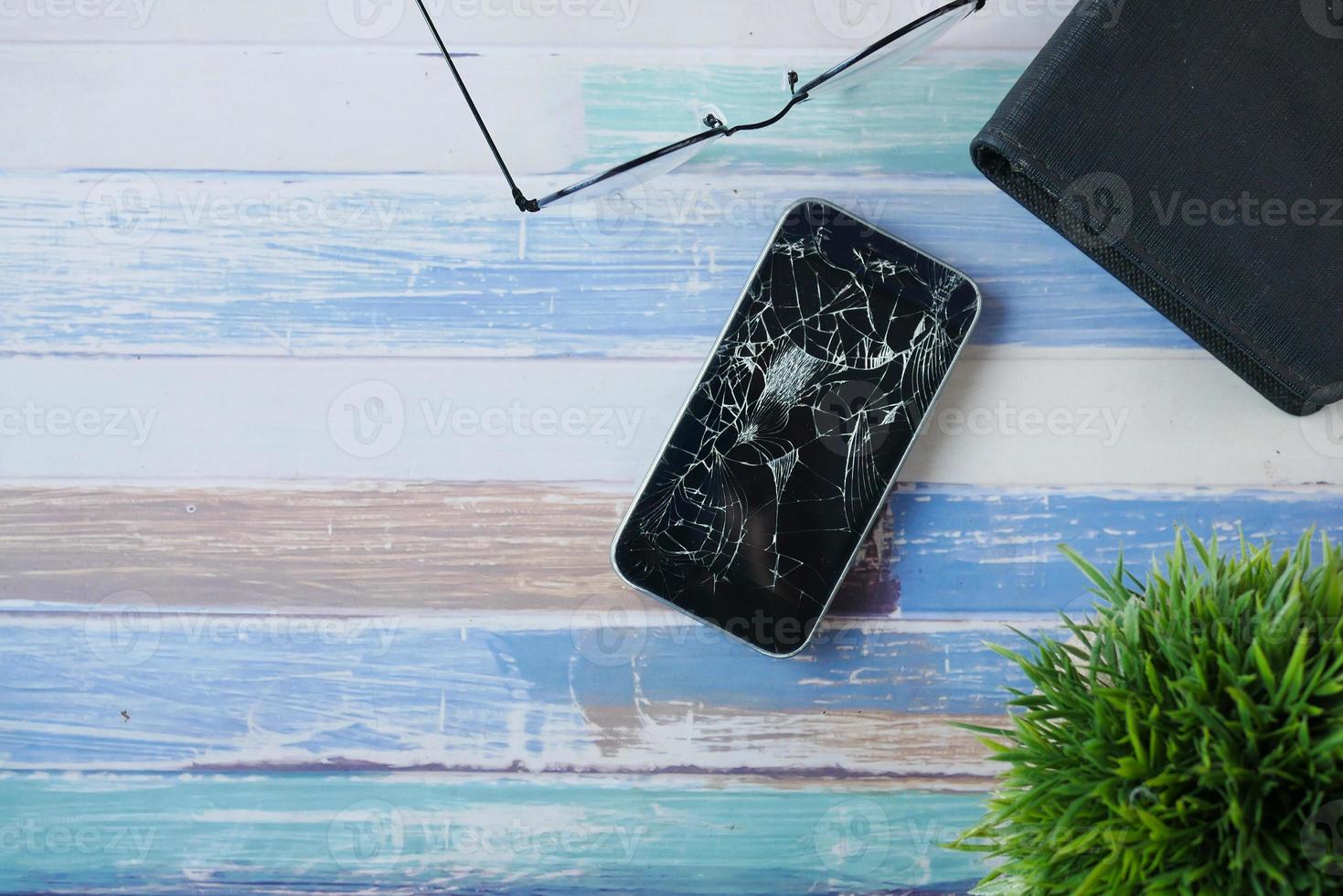 Top view of broken smart phone on color background photo