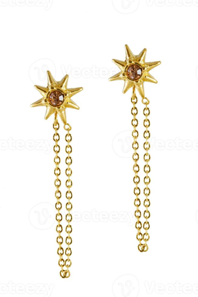 Golden earrings star shaped isolated on a white background photo